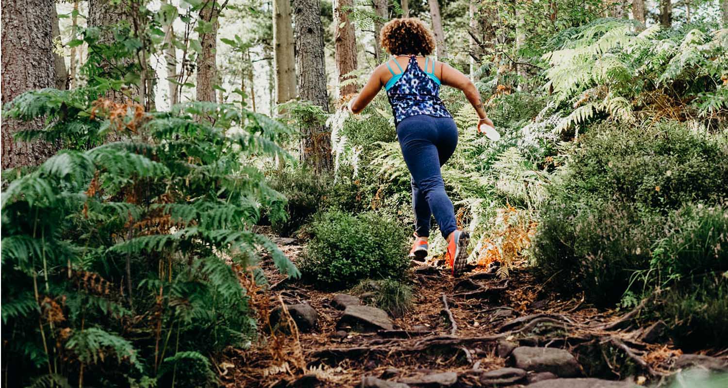 women run and bike faster after taking newly developed supplement_woman running in woods