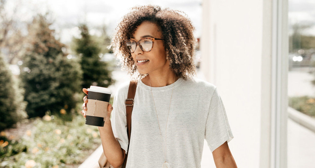 Woman walking outside with coffee