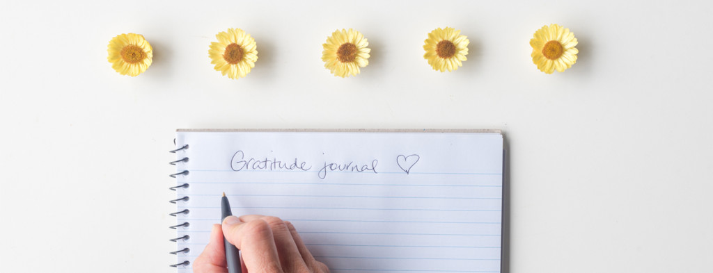 Writing gratitudes in notebook