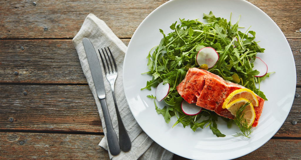 Salmon and greens on white plate