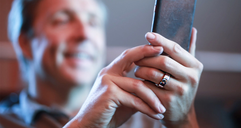 Dave Asprey using phone while wearing Oura ring