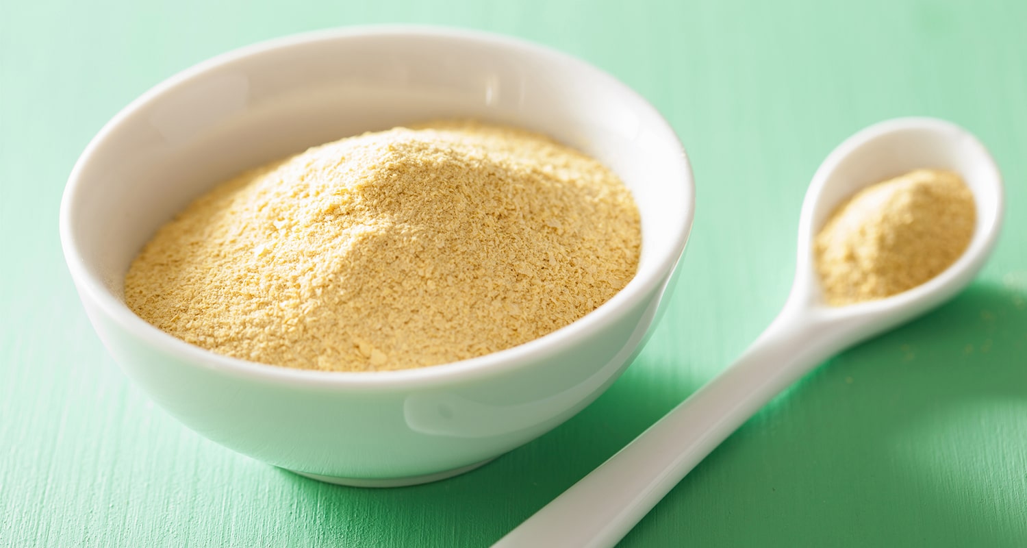 Bowl and spoon of nutritional yeast