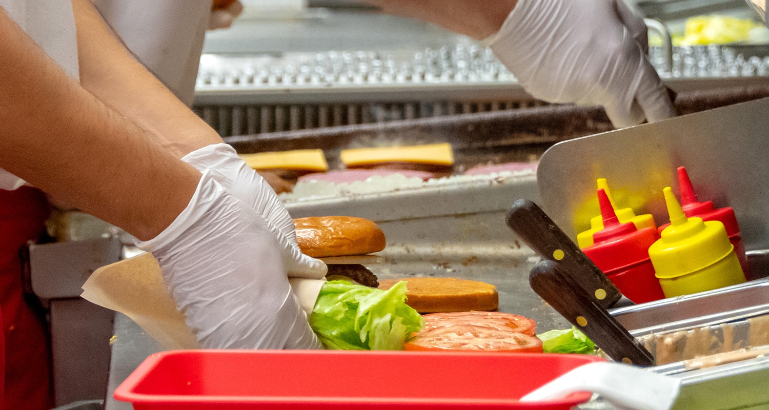 fast food worker making burgers
