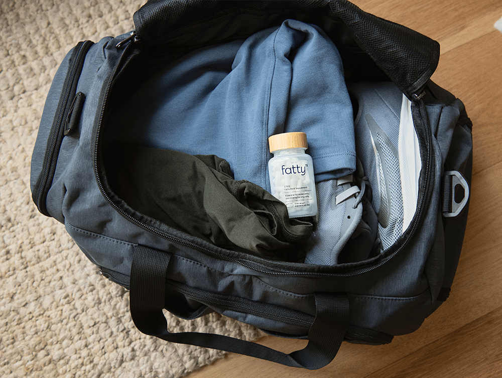 Bottle of Fatty™ Supplements in a gym bag