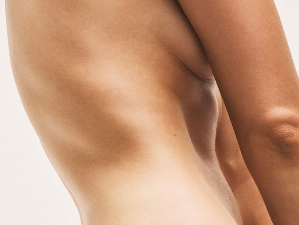 Side profile of a naked woman’s side.
