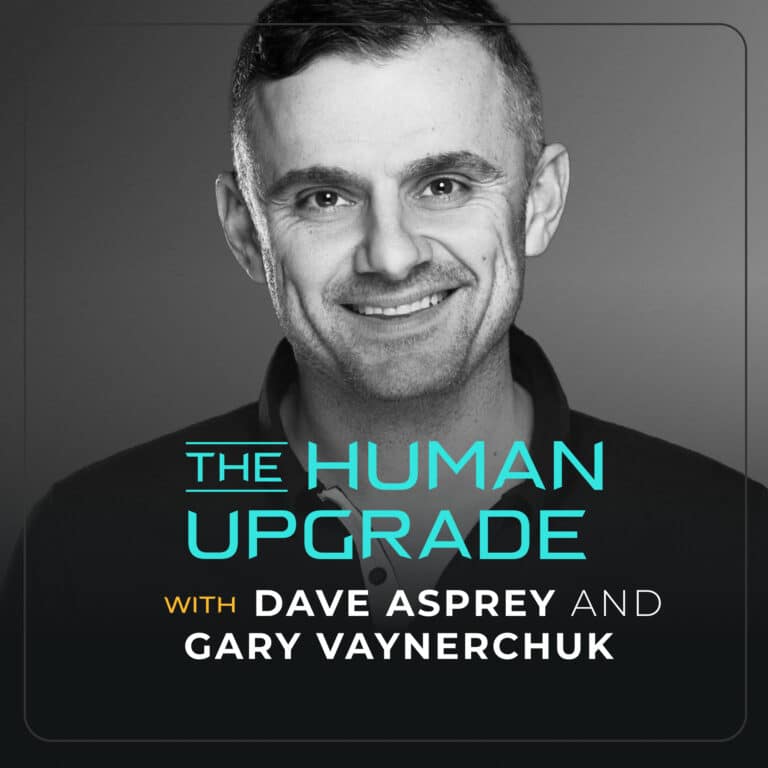 Black and white photo of a smiling man. Text on the image reads: The Human Upgrade with Dave Asprey and Gary Vaynerchuk. The text is in blue, white, and yellow fonts on a gray background.