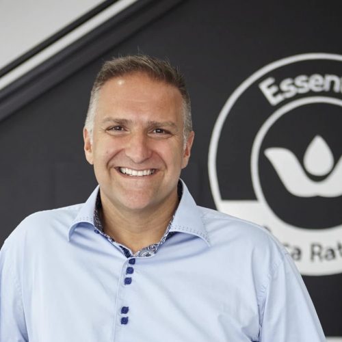 Man in collared shirt smiling