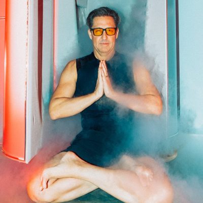 Dave Asprey meditating in front of cryotherapy chamber