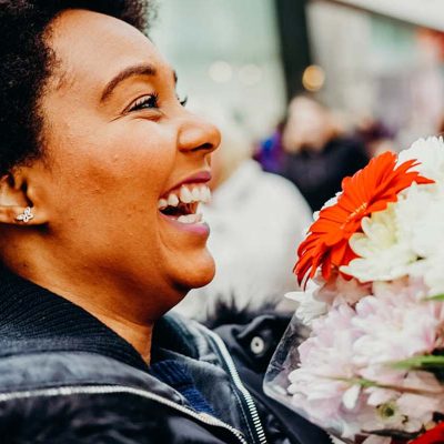 28 days of kindness_woman surprised by flowers