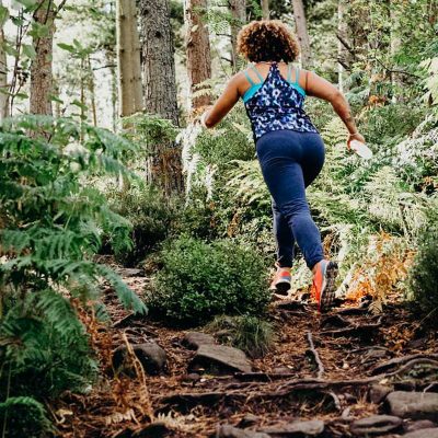 women run and bike faster after taking newly developed supplement_woman running in woods